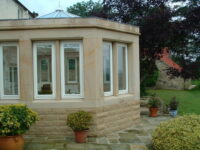 A photo from a recently completed BBS project, titled 'Natural Stone Walling and Masonry for Conservatory in Scotton, North Yorkshire'