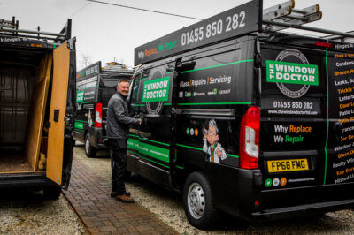 A photo of a Window Doctor engineer next to his van